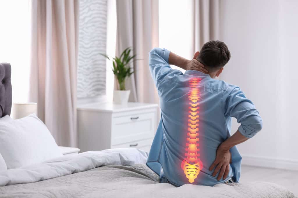 Man with lower back pain having trouble sleeping